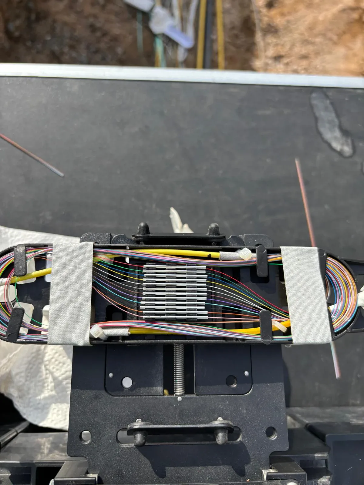 Close-up of a splice tray with organized fiber connections