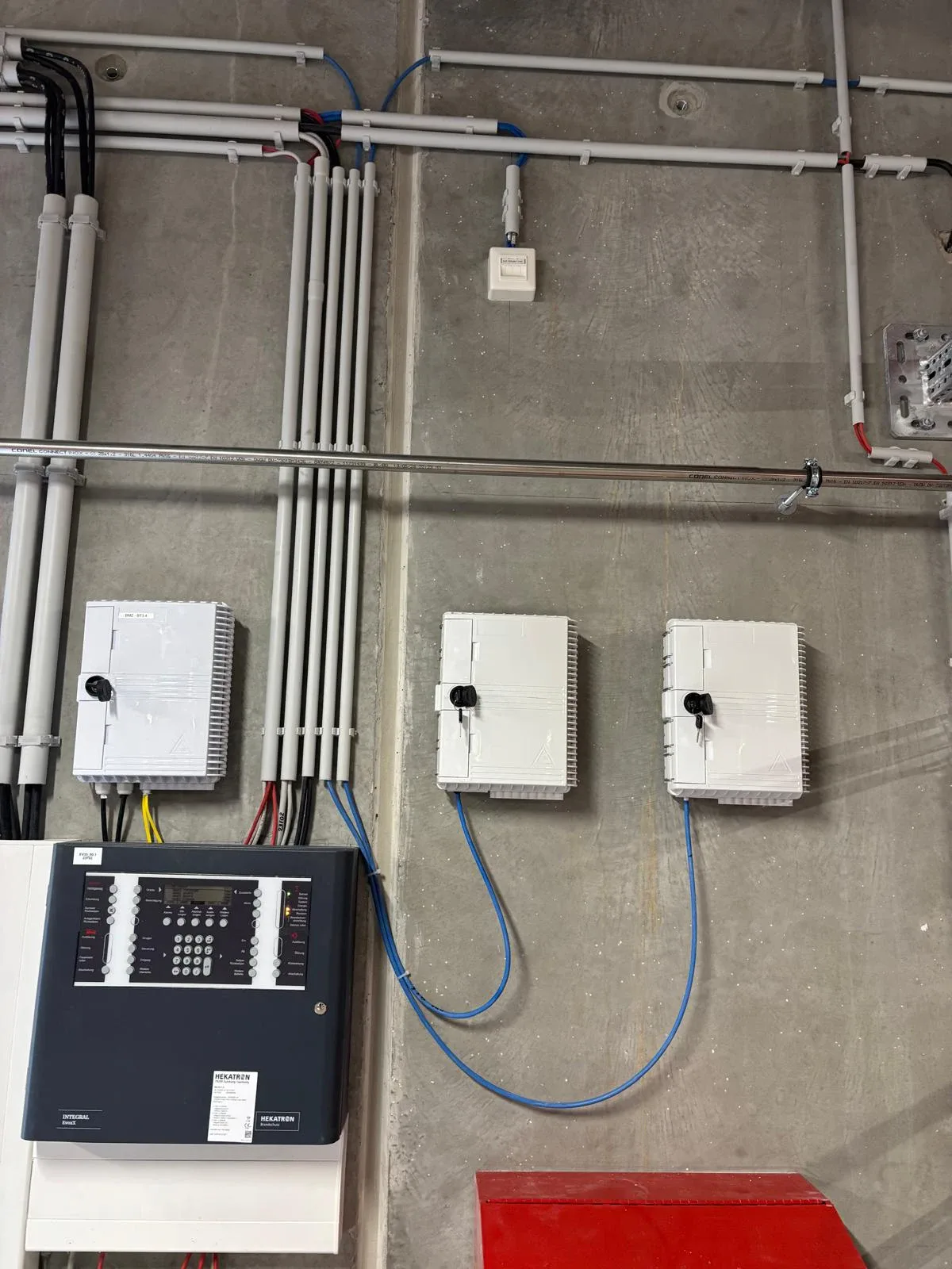 Wall-mounted fiber boxes and conduit routing after installation